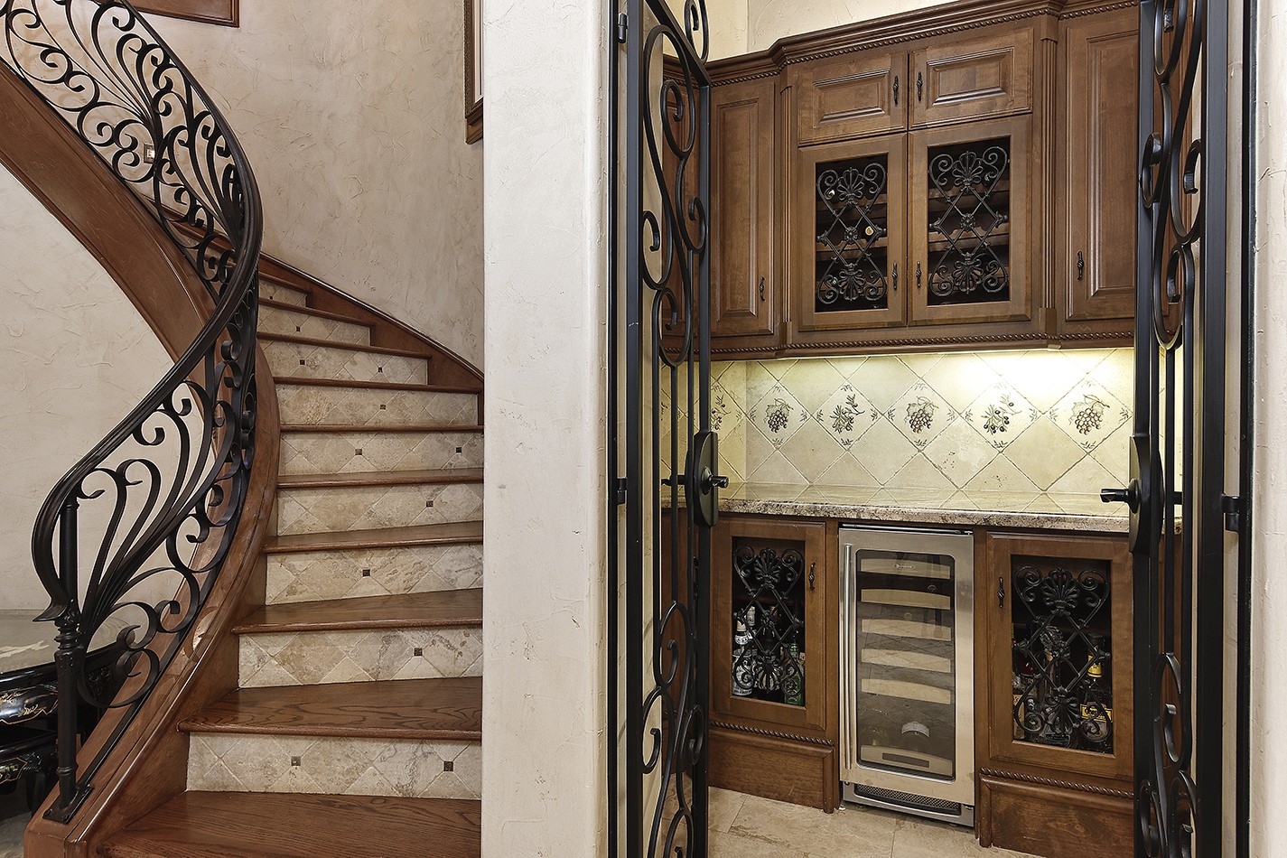 134 South Tranquil Path The Woodlands, TX 77380 - Photo 16 of 49 Rear stairway. Wine bar with iron gate.