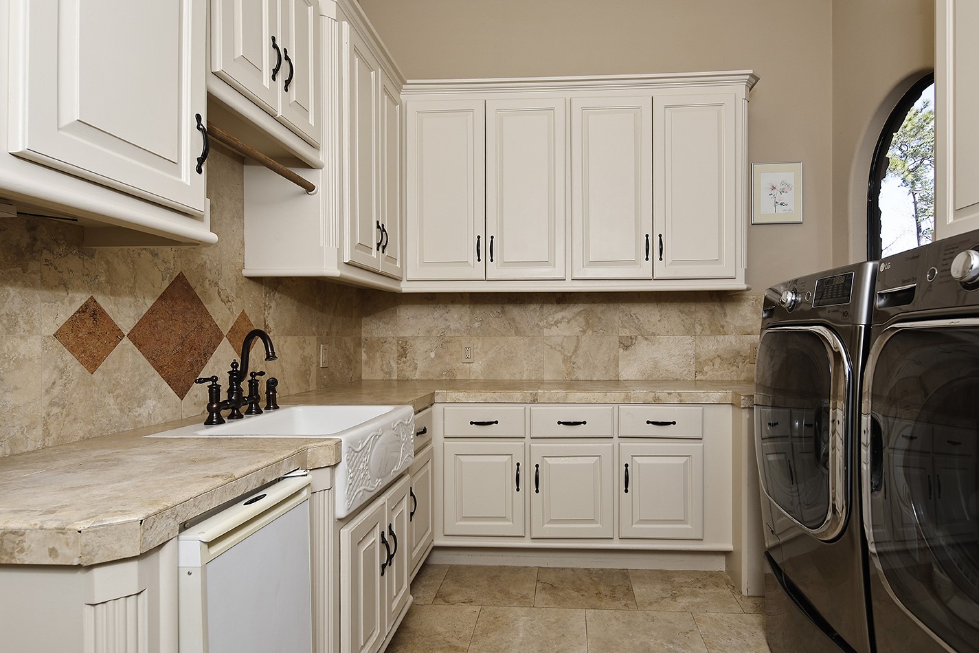 134 South Tranquil Path The Woodlands, TX 77380 - Photo 18 of 49 Spacious laundry room with 2 clothes hanging rods, room for extra fridge, farm sink, ice maker and window to courtyard.