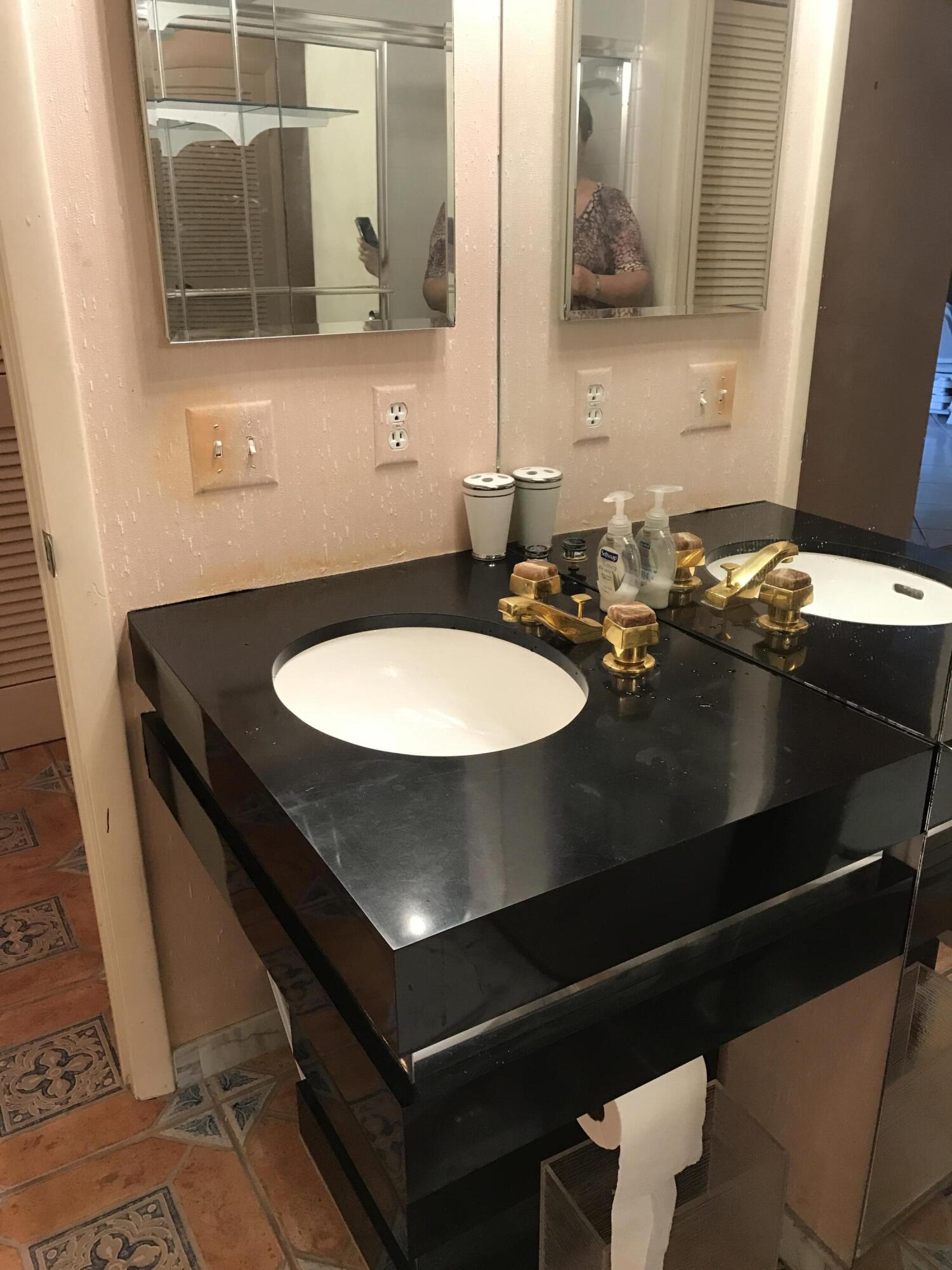 2520 Presidential Way, Unit 205 West Palm Beach, FL 33401 - Photo 15 of 22 a bathroom with a sink and mirror