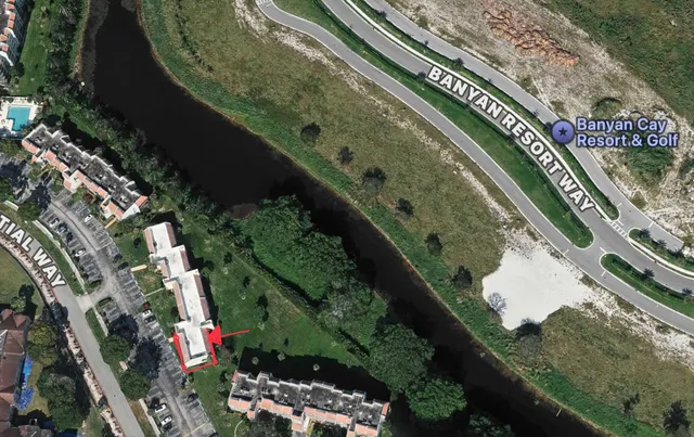 a view of hallway with a large window and wooden floor