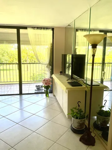 a porch with a chair and a rug