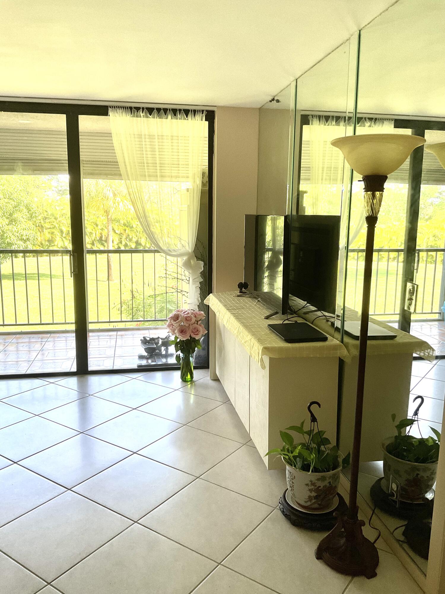 2520 Presidential Way, Unit 205 West Palm Beach, FL 33401 - Photo 8 of 22 a living room with a large window and furniture