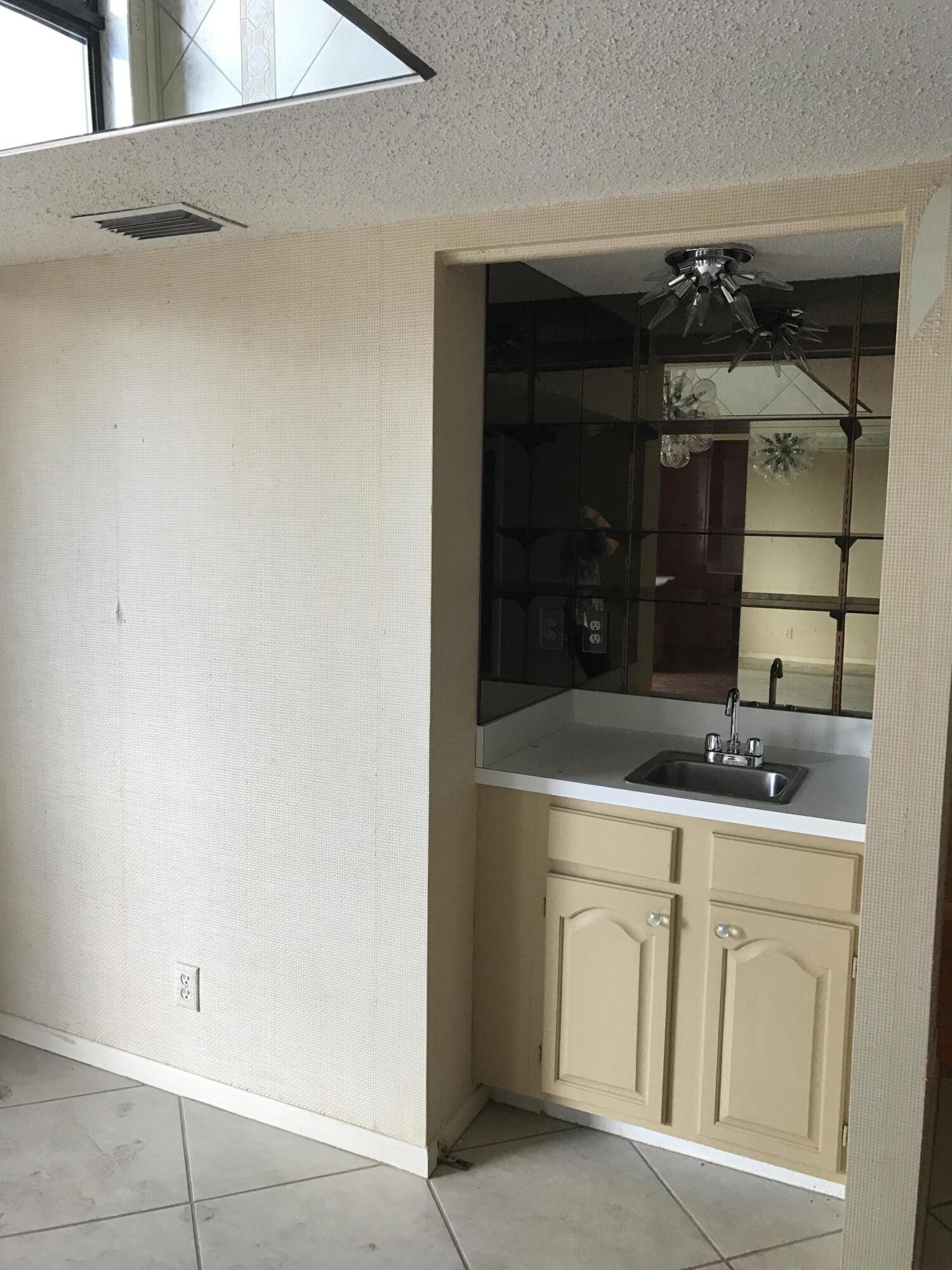2520 Presidential Way, Unit 205 West Palm Beach, FL 33401 - Photo 10 of 22 a bathroom with a sink and a mirror