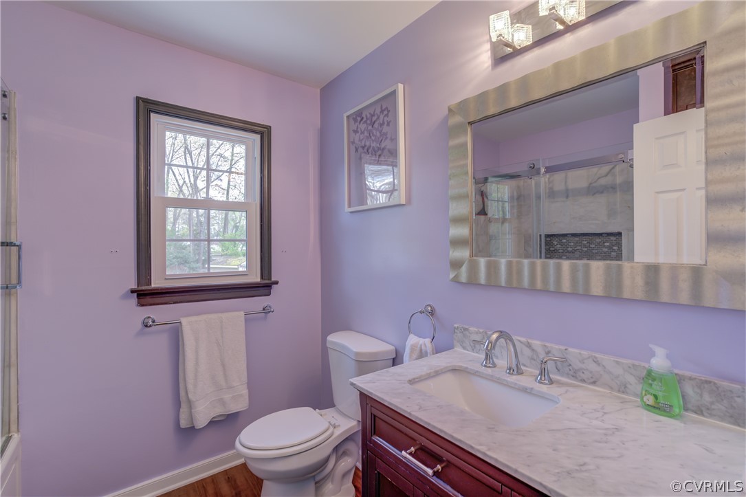 2863 Iverson Road Midlothian, VA 23112 - Photo 26 of 38 a bathroom with a granite countertop toilet a sink and a mirror