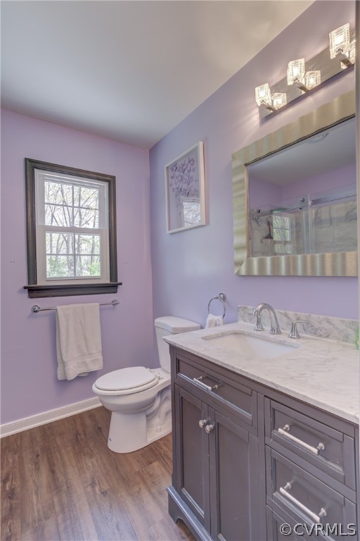 2863 Iverson Road Midlothian, VA 23112 - Photo 27 of 38 a bathroom with a granite countertop toilet a sink a mirror and a window