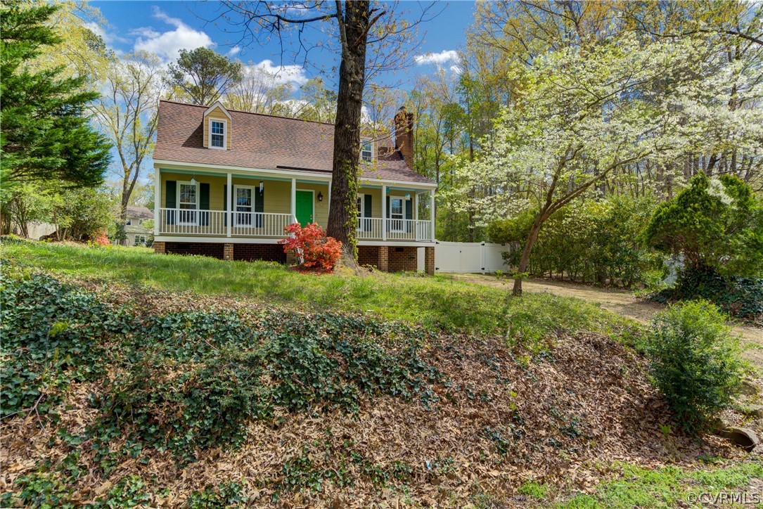 2863 Iverson Road Midlothian, VA 23112 - Photo 3 of 38 a view of an brick house with a big yard and large trees
