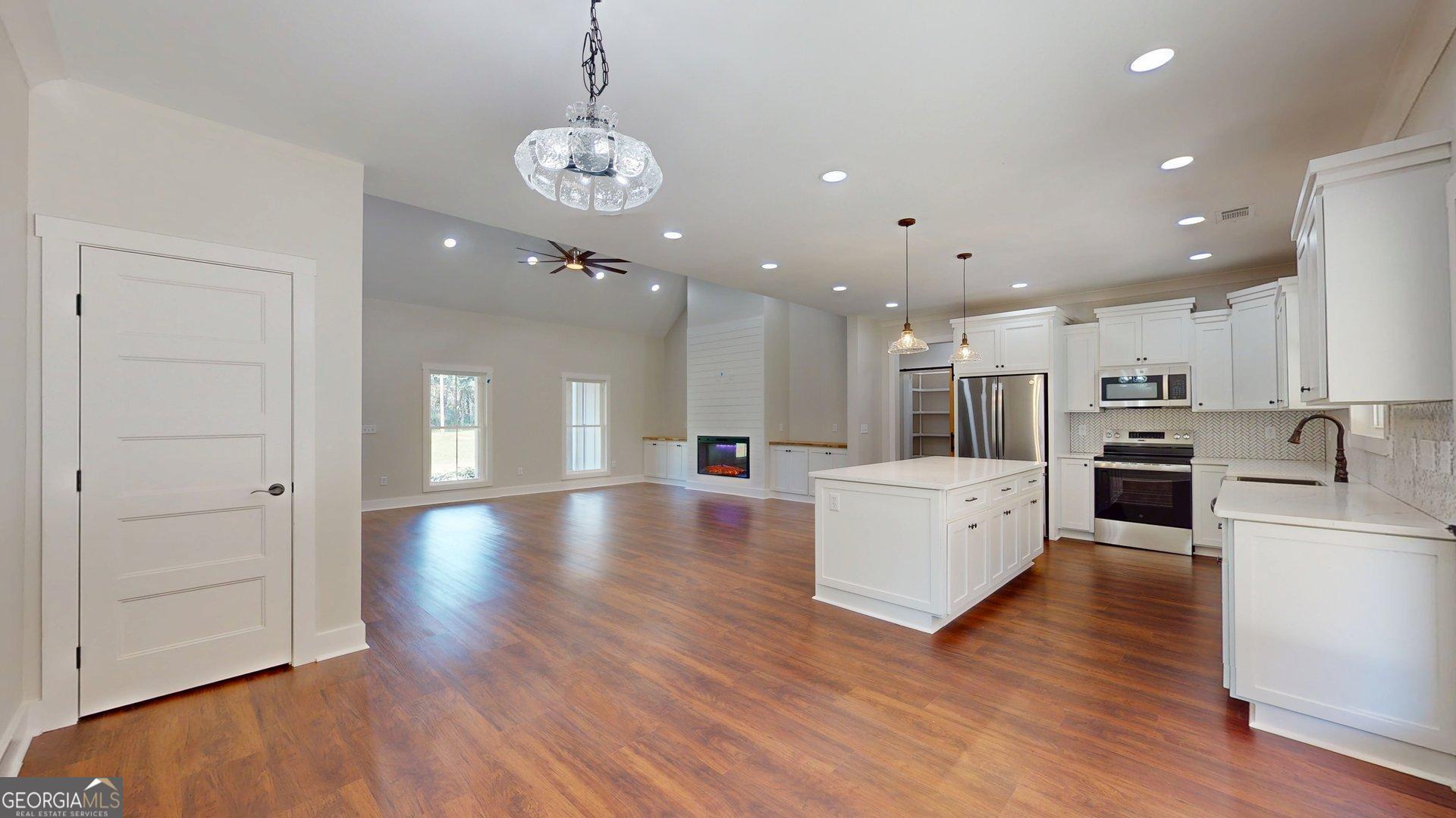 53 Jericho Lane Brooklet, GA 30415 - Photo 14 of 54 a view of a kitchen with kitchen island stainless steel appliances wooden floor and refrigerator