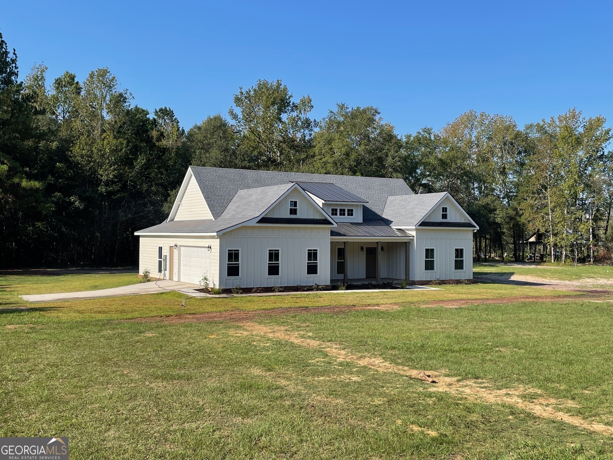 53 Jericho Lane Brooklet, GA 30415 - Photo 2 of 54 a white house with a big yard and large trees with large windows