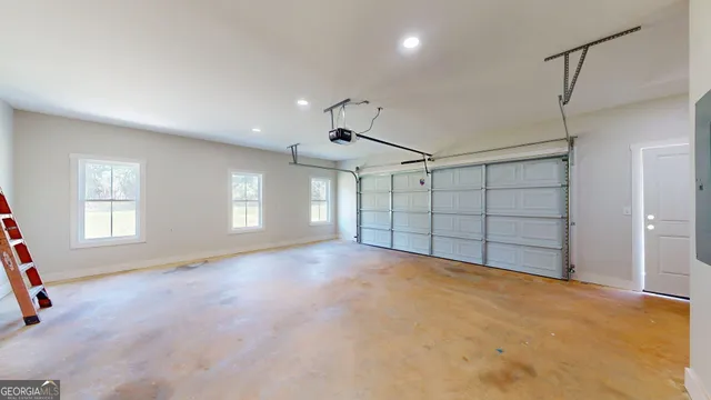 a view of a hallway with wooden floor and closet area
