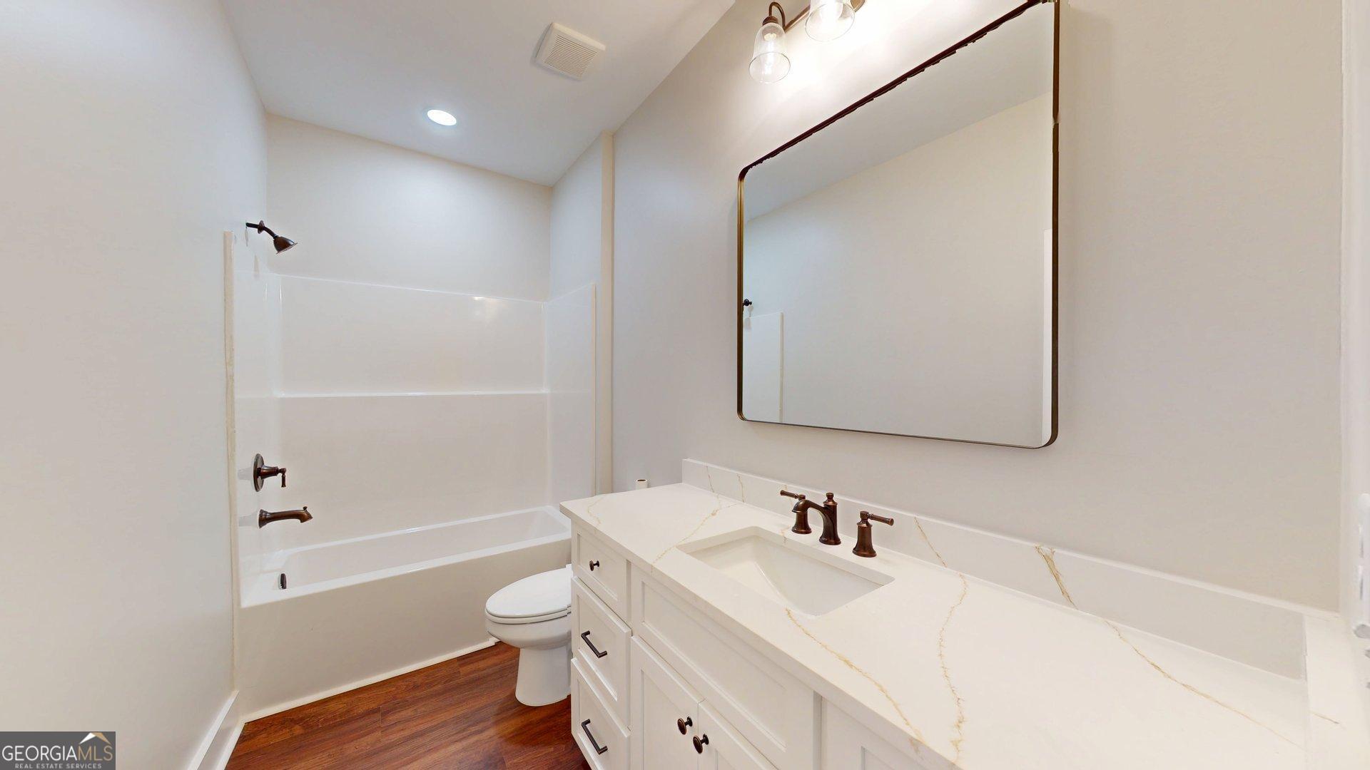 53 Jericho Lane Brooklet, GA 30415 - Photo 31 of 54 a bathroom with a sink a toilet and a bathtub