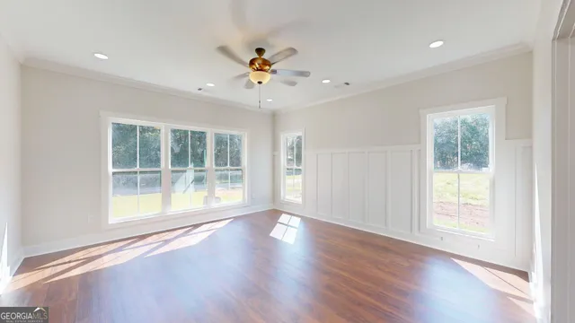 a bathroom with bathtub wooden floor and windows