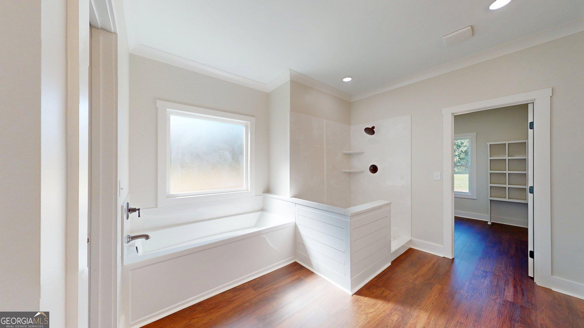 53 Jericho Lane Brooklet, GA 30415 - Photo 40 of 54 a bathroom with bathtub wooden floor and windows