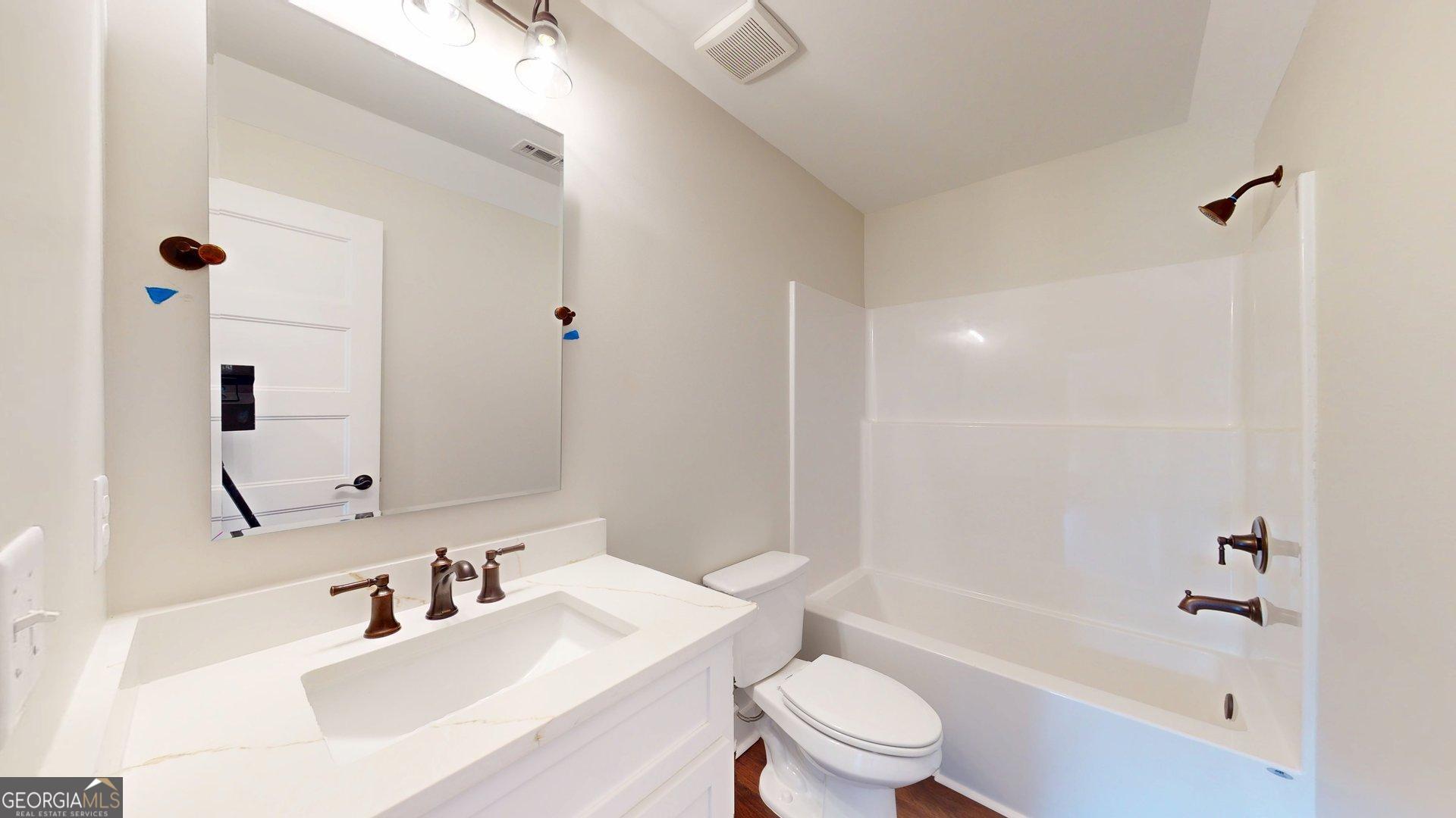 53 Jericho Lane Brooklet, GA 30415 - Photo 48 of 54 a bathroom with a sink a toilet and shower