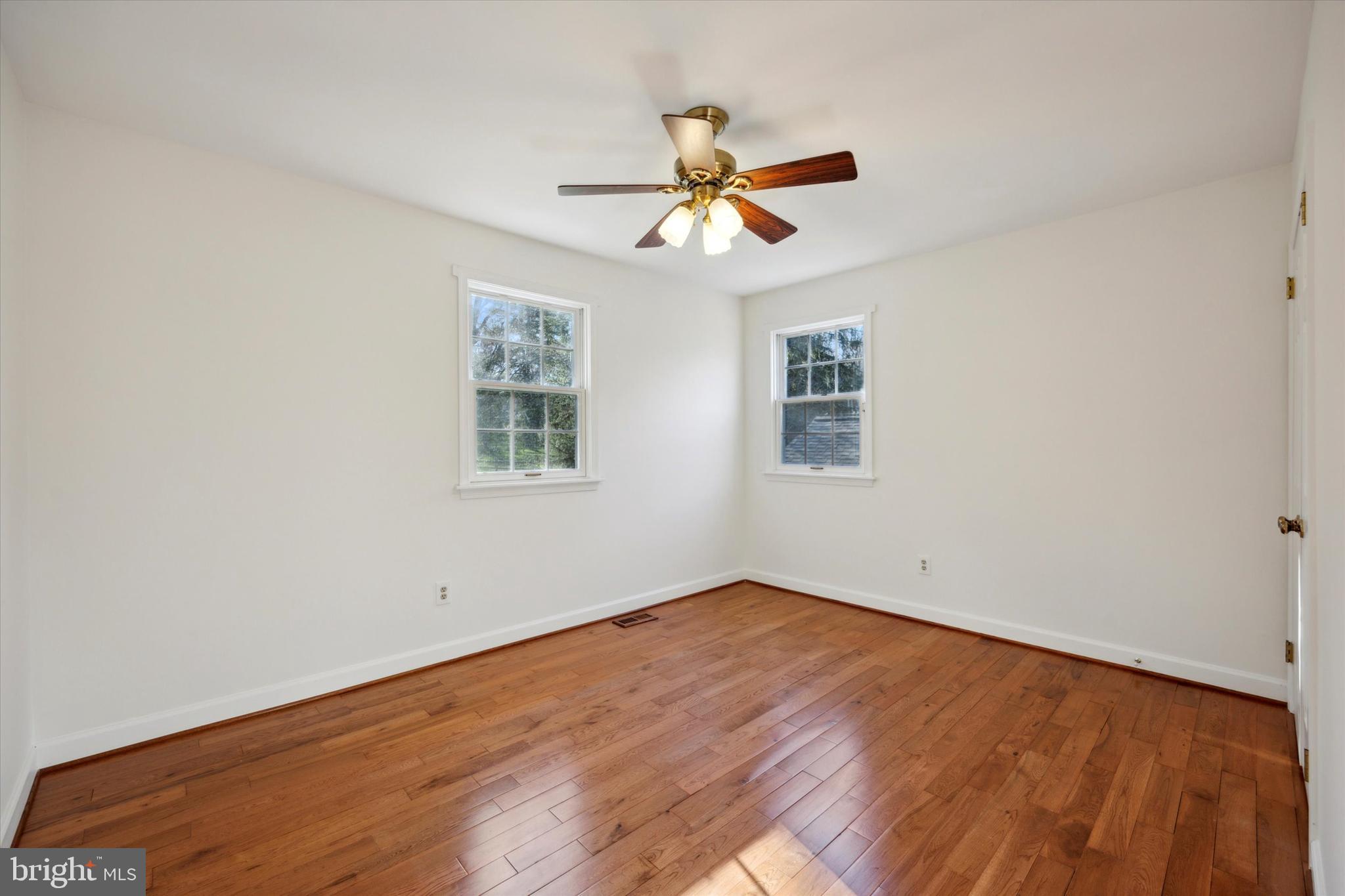 844 Hunt Road Newtown Square, PA 19073 - Photo 26 of 35 a view of an empty room with window and wooden floor