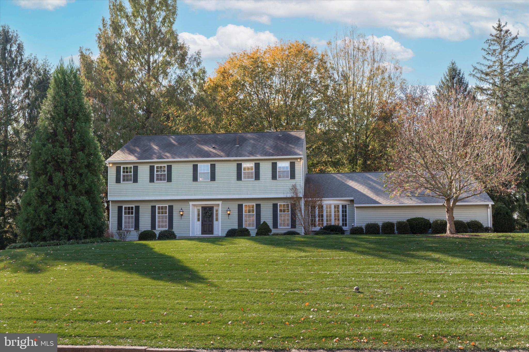 844 Hunt Road Newtown Square, PA 19073 - Photo 3 of 35 a front view of a house with a garden and trees