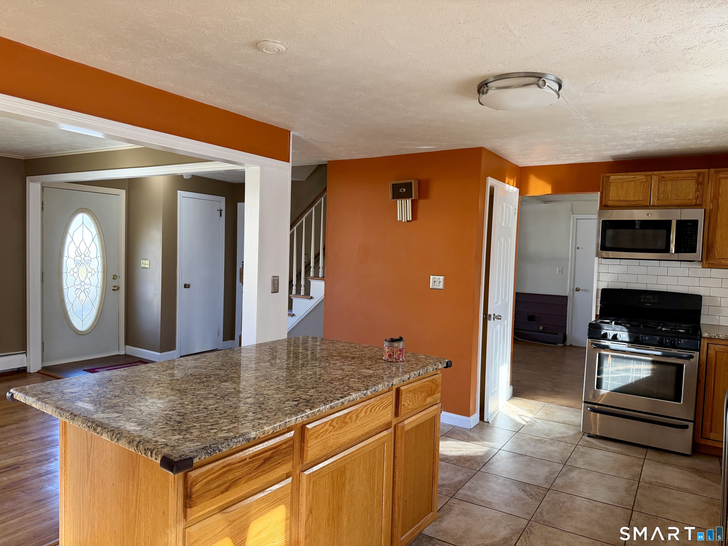 44 Crabapple Road Windsor, CT 06095 - Photo 12 of 38 a kitchen with stainless steel appliances granite countertop a stove a sink and a refrigerator