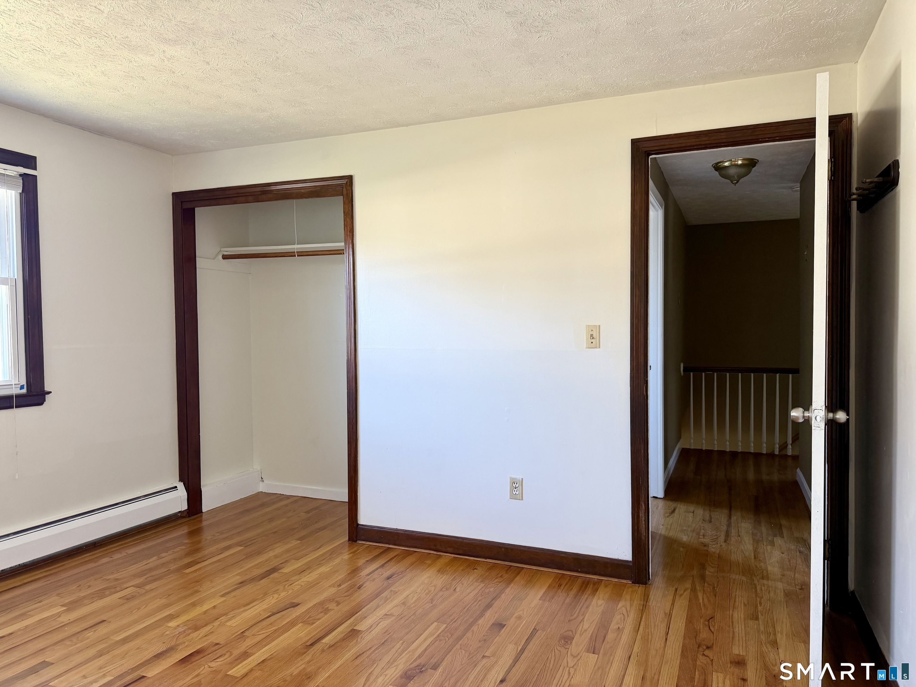44 Crabapple Road Windsor, CT 06095 - Photo 13 of 38 a view of an empty room with wooden floor and a window
