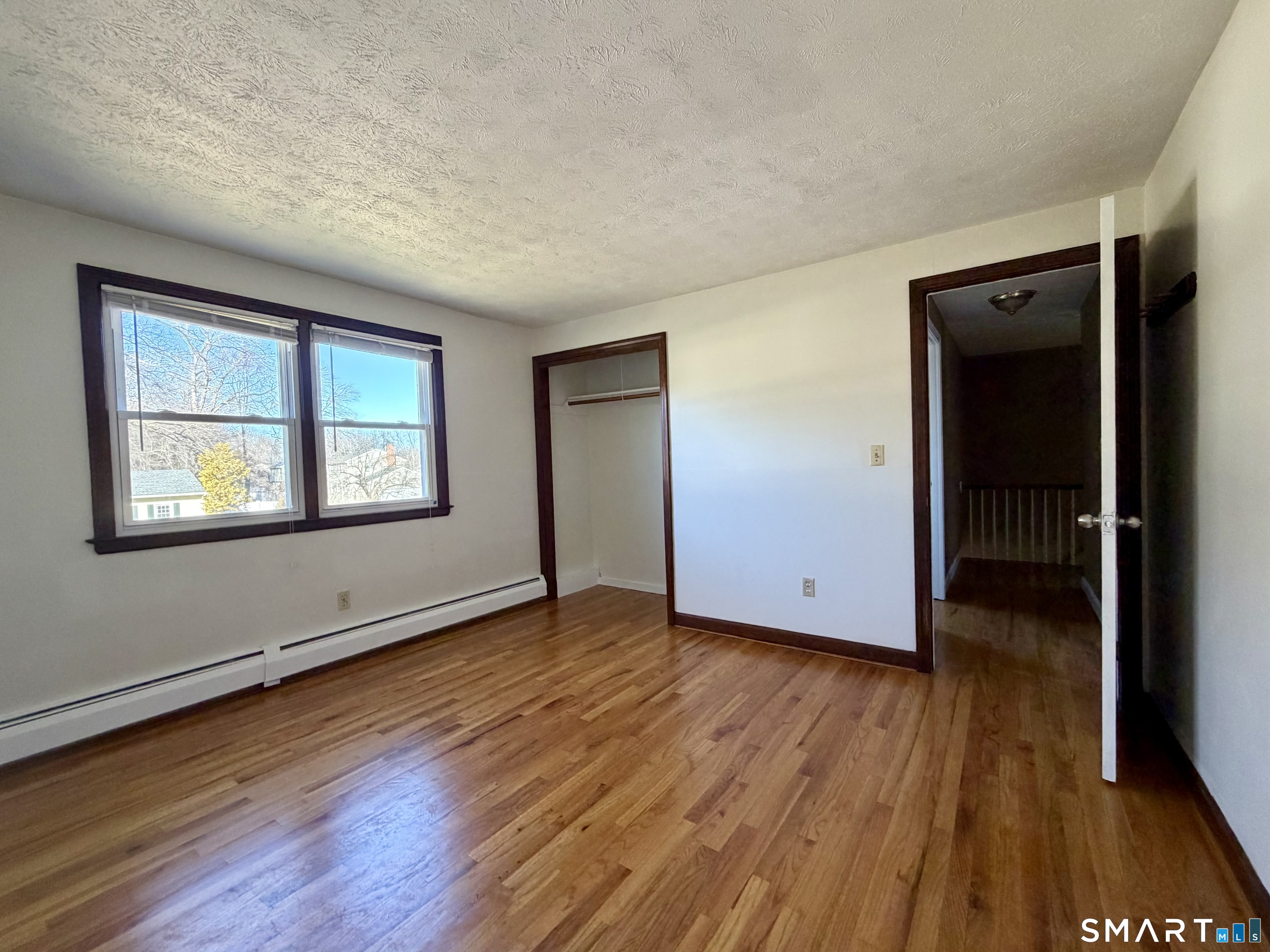 44 Crabapple Road Windsor, CT 06095 - Photo 14 of 38 an empty room with wooden floor and windows