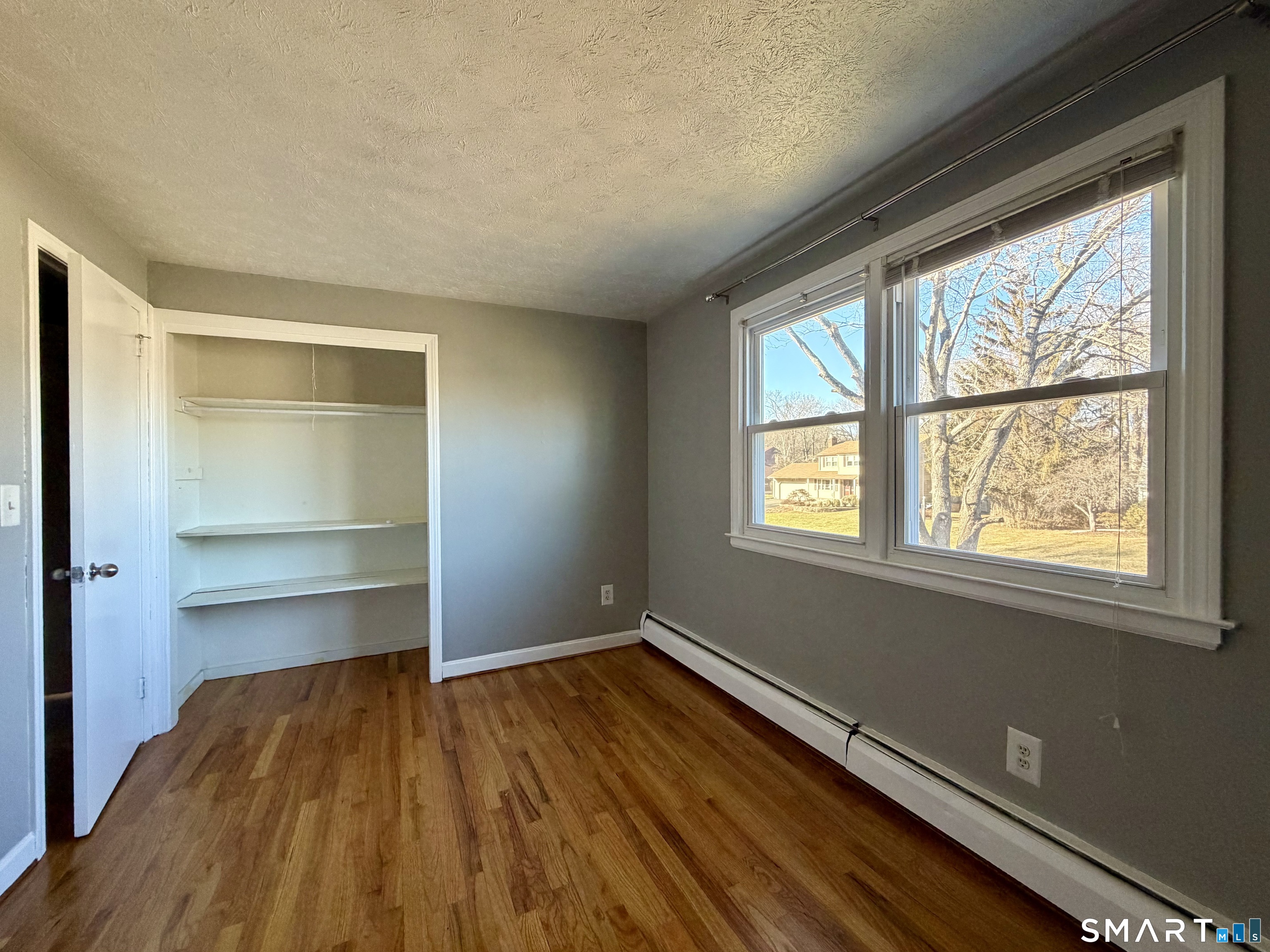 44 Crabapple Road Windsor, CT 06095 - Photo 16 of 38 a view of an empty room with a window and wooden floor