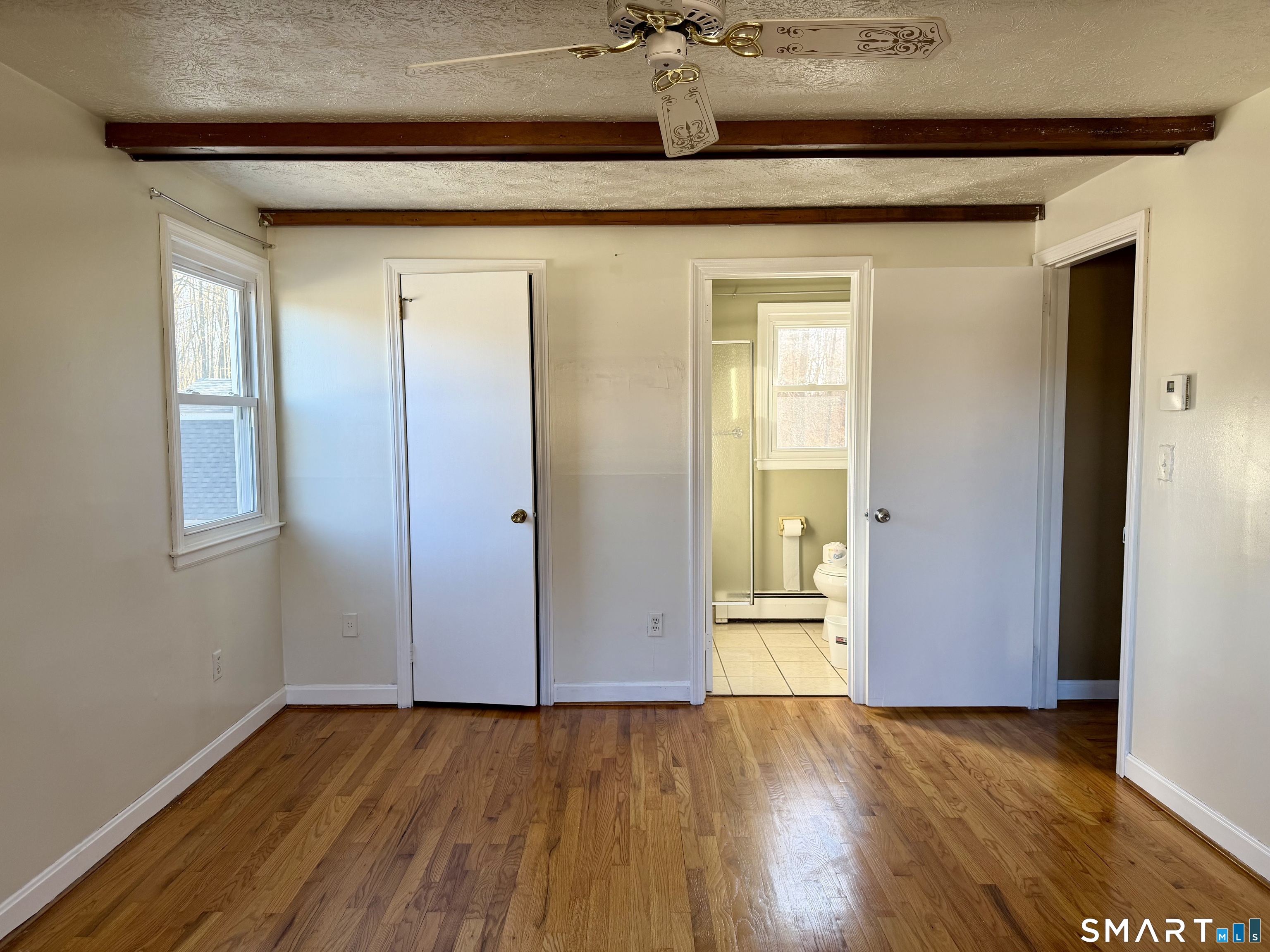 44 Crabapple Road Windsor, CT 06095 - Photo 32 of 38 an empty room with wooden floor and windows
