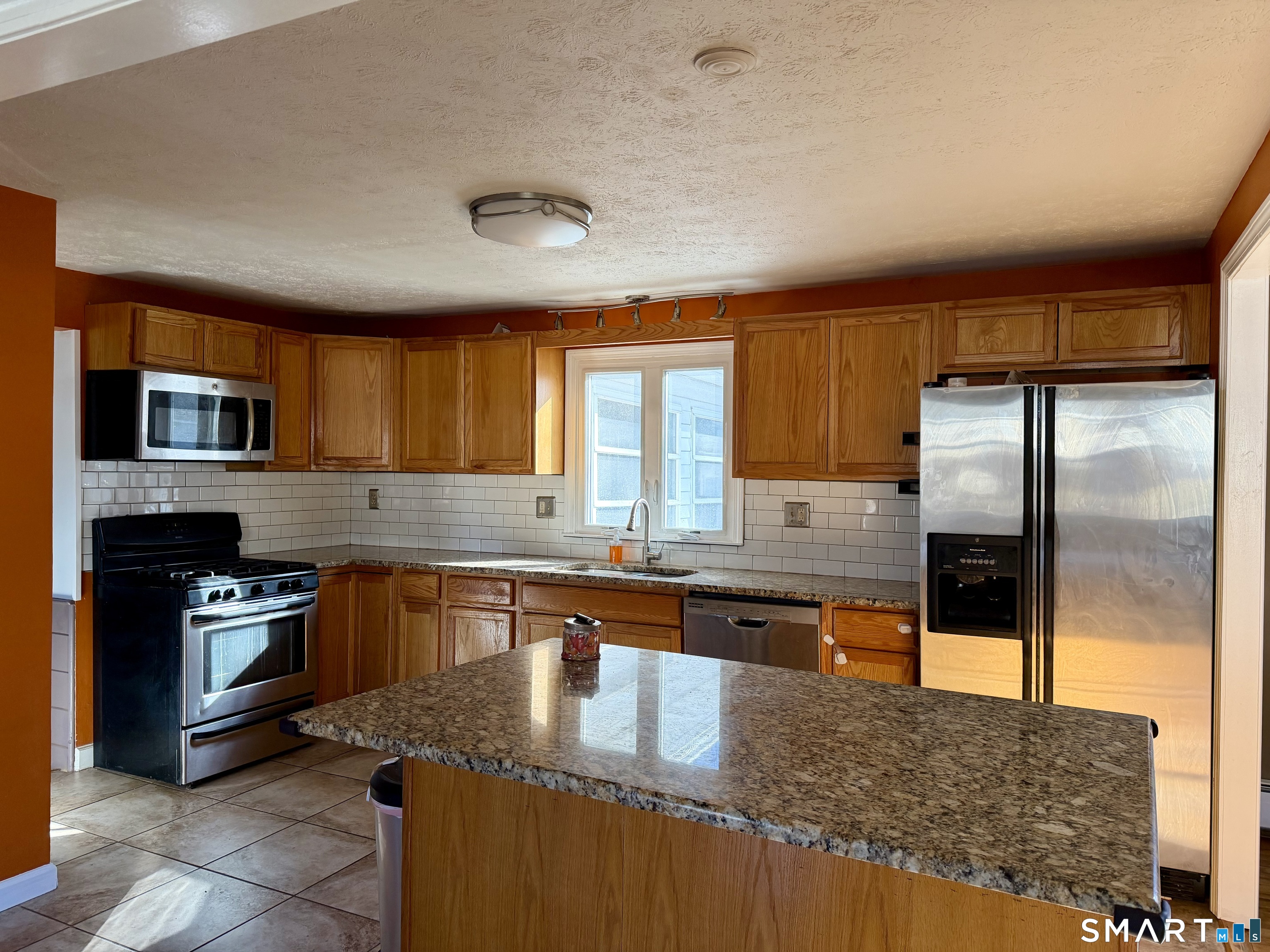 44 Crabapple Road Windsor, CT 06095 - Photo 8 of 38 a kitchen with stainless steel appliances granite countertop a sink a stove and a refrigerator