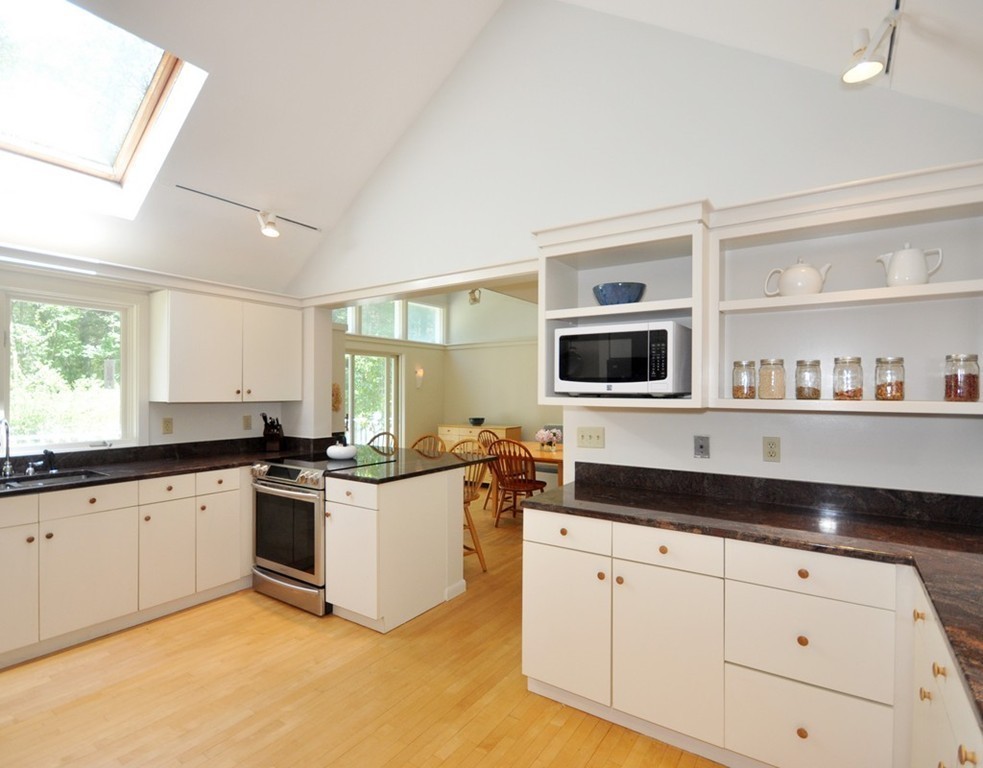 163 Sunset Road Carlisle, MA 01741 - Photo 6 of 19 a kitchen with stainless steel appliances granite countertop a stove a sink and a microwave