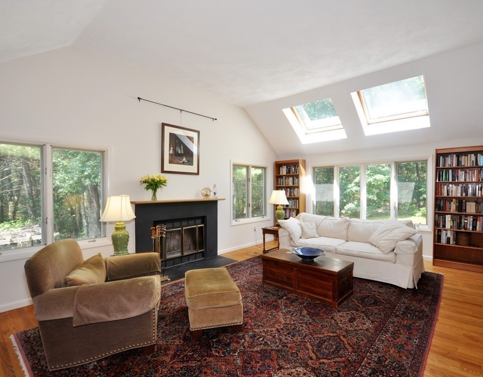 163 Sunset Road Carlisle, MA 01741 - Photo 8 of 19 a living room with furniture fireplace and a large window