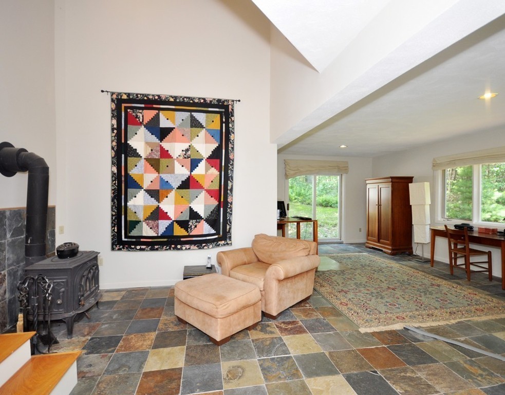 163 Sunset Road Carlisle, MA 01741 - Photo 10 of 19 a living room with furniture a rug and a wall painting
