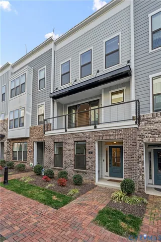 a front view of residential houses with yard and green space