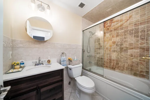 a bathroom with a sink a toilet and a shower