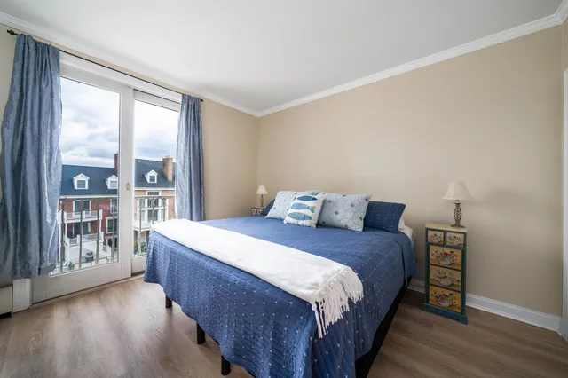 a bedroom with a large bed and a large window