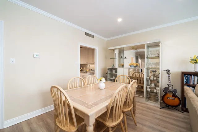 a dining room with furniture and wooden floor