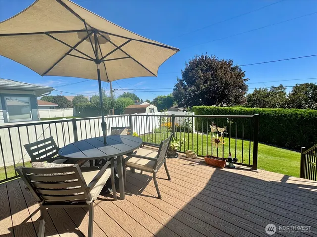 a view of a deck with furniture and barbeque grill with wooden floor