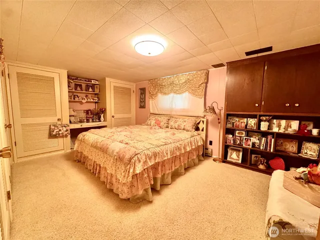 a spacious bedroom with a bed and a walk in closet