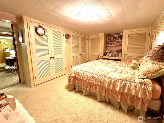 a spacious bedroom with a bed and a large mirror