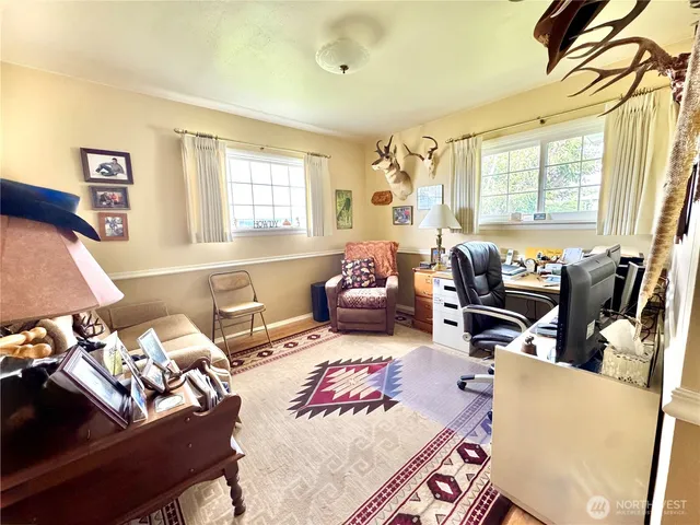 a bedroom with furniture and a large window