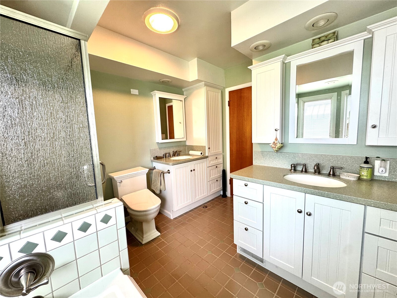 309 West 9th Avenue Ritzville, WA 99169 - Photo 8 of 31 a spacious bathroom with a double vanity sink a toilet and a mirror