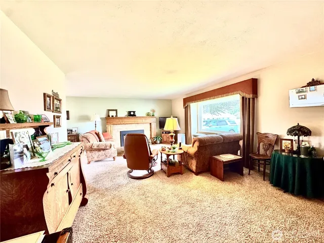 a living room with furniture a flat screen tv and next to a window