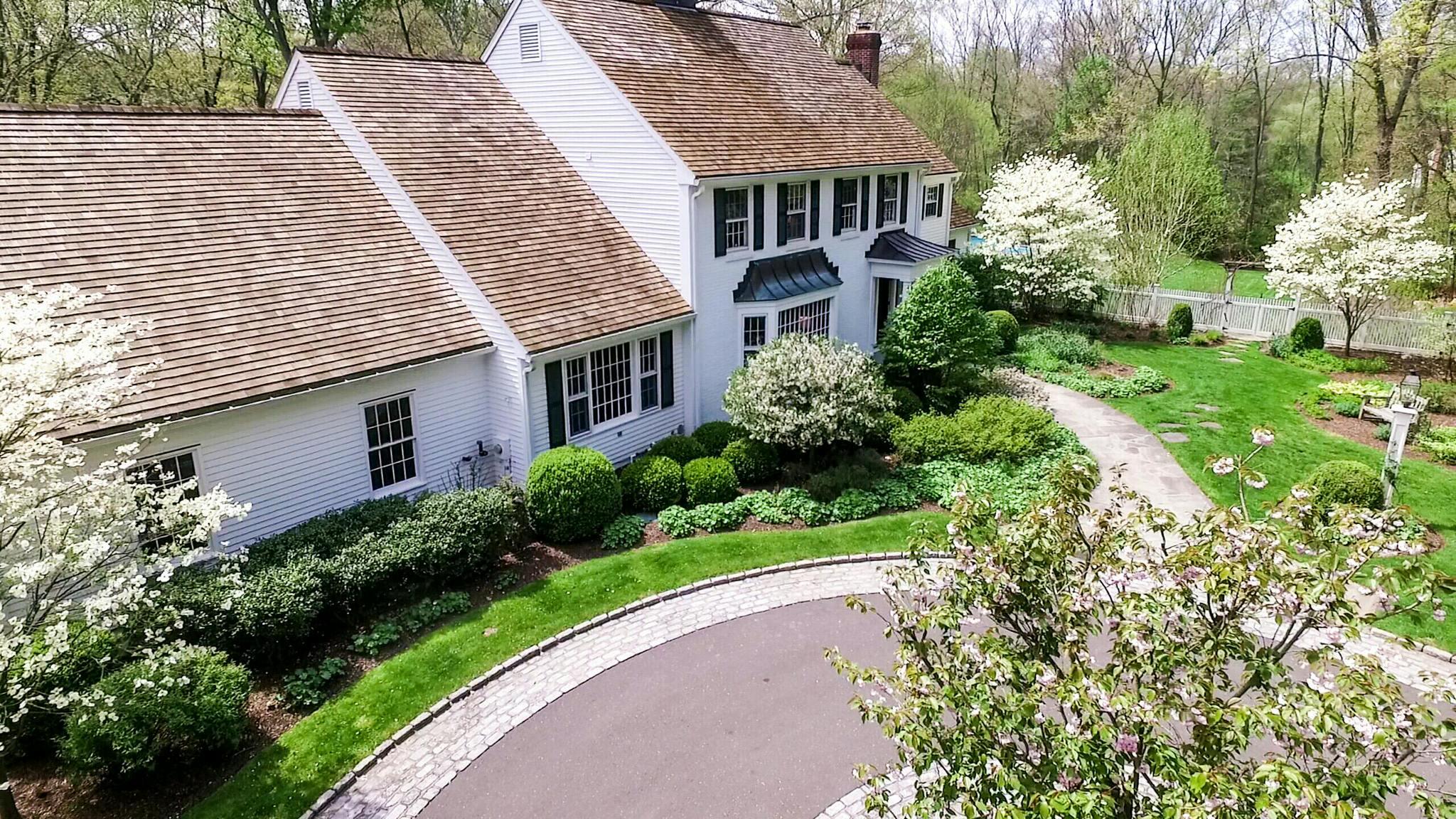 a aerial view of a house with a yard and potted plants