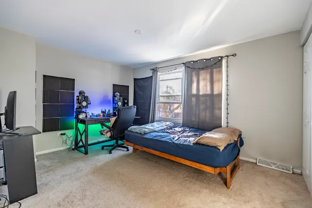 a bedroom with a bed and a table