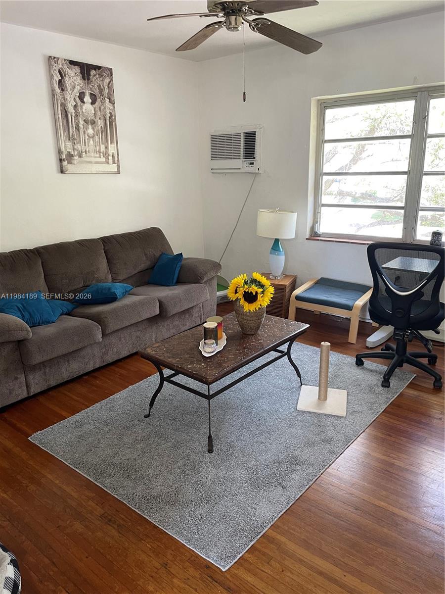 7734 Southwest 55th Avenue, Unit C Miami, FL 33143 - Photo 1 of 6 a living room with furniture and a window