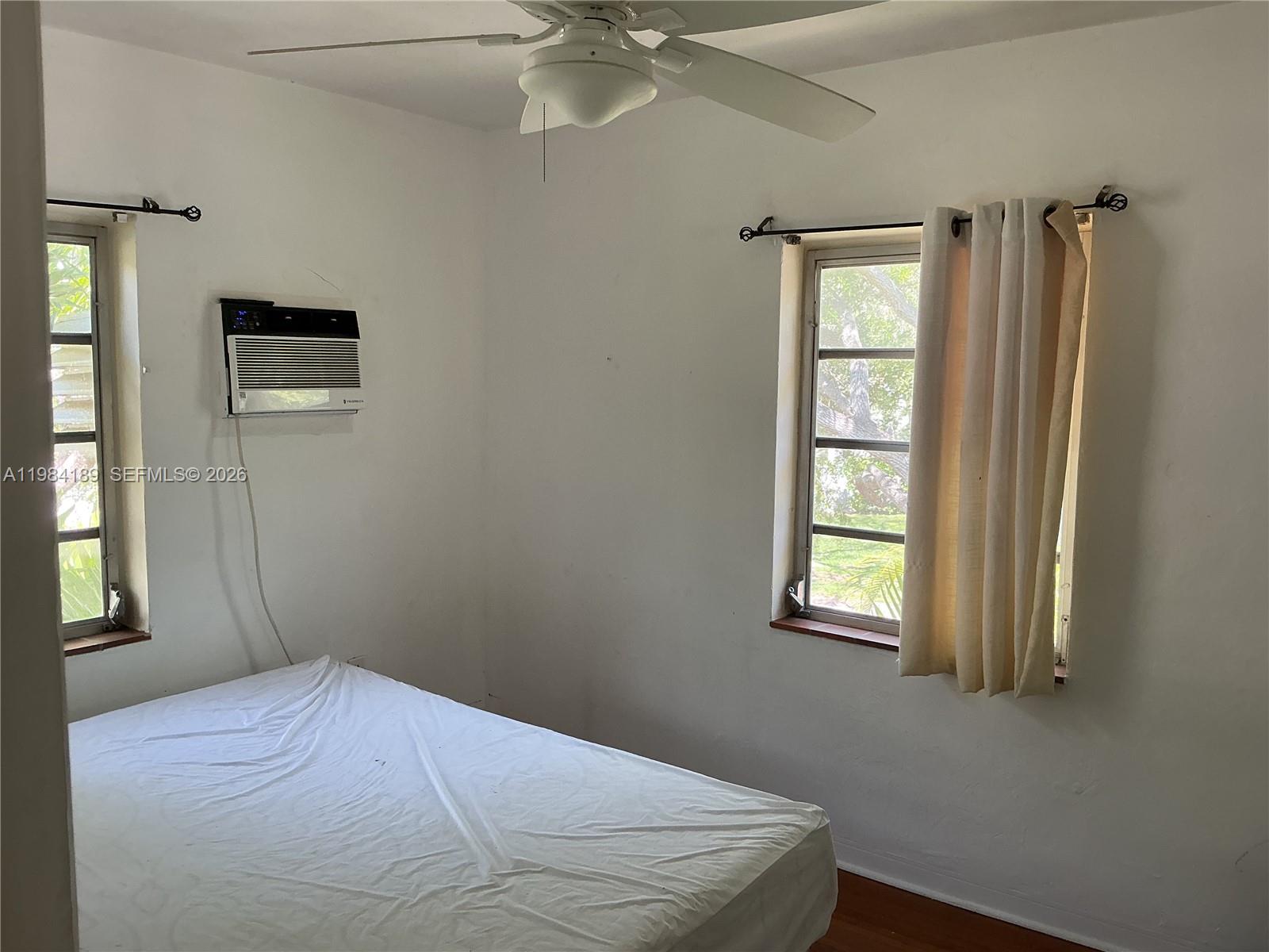 7734 Southwest 55th Avenue, Unit C Miami, FL 33143 - Photo 5 of 6 a bedroom with a bed and a window