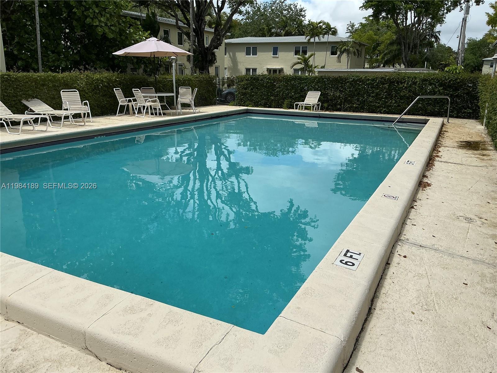 7734 Southwest 55th Avenue, Unit C Miami, FL 33143 - Photo 6 of 6 a view of swimming pool with chairs in patio