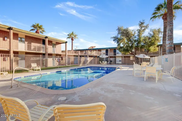 a view of a swimming pool with a lounge chairs