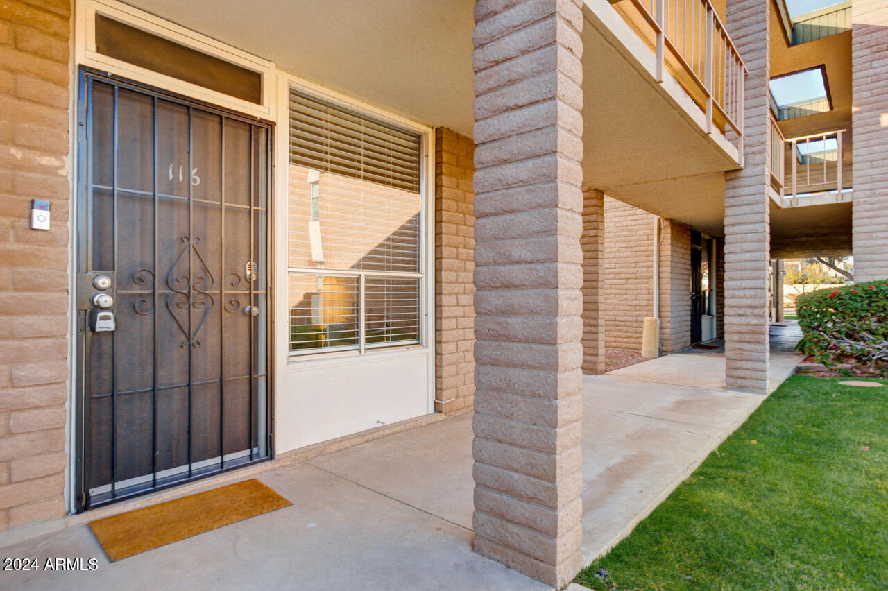 3737 East Turney Avenue, Unit 116 Phoenix, AZ 85018 - Photo 16 of 24 a front view of a house with a yard