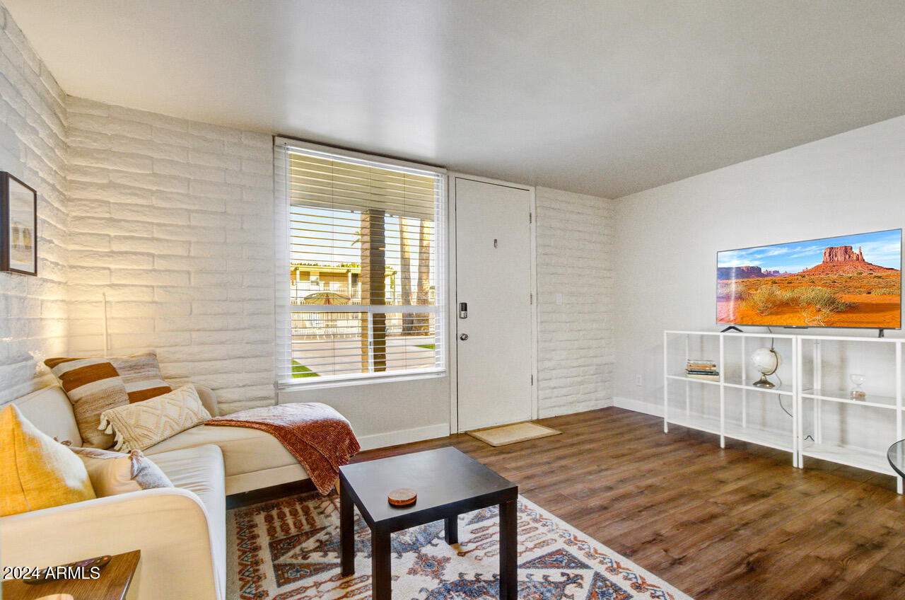 3737 East Turney Avenue, Unit 116 Phoenix, AZ 85018 - Photo 2 of 24 a bedroom with furniture and a window