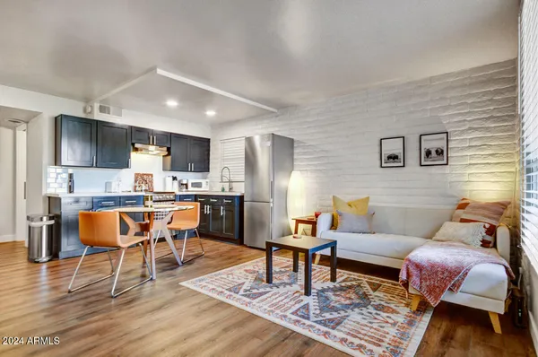 a living room with furniture and a dining table with kitchen view