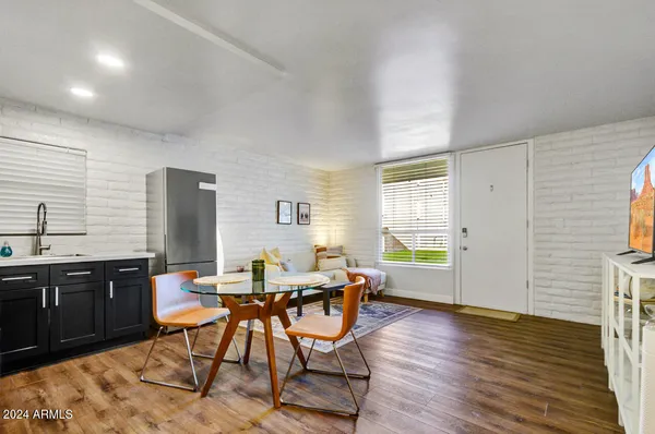 a view of a dining room with furniture and wooden floor