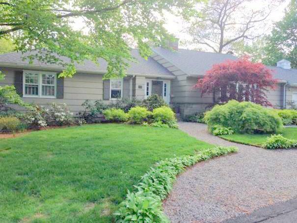a front view of a house with garden