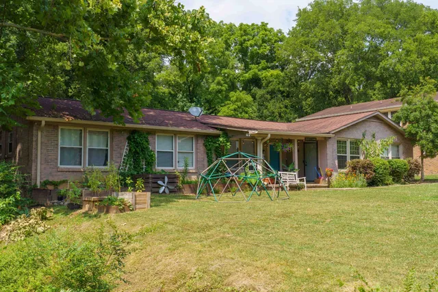 a front view of a house with patio yard and outdoor seating